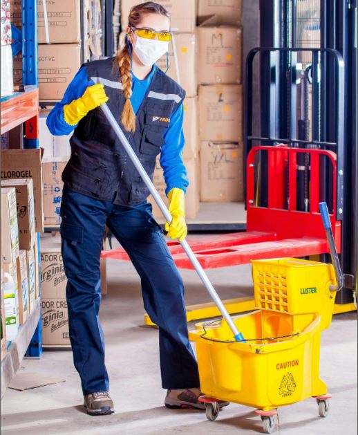 agent logistique en train de nettoyer l'entrepôt